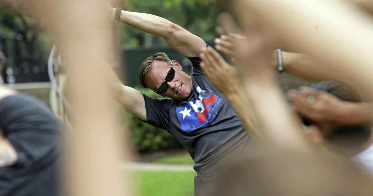 Texas Railroad Commissioner Ryan Sitton leads a workout group on the lawn of the State Capitol in honor of Global Employee Health and Fitness Month and in collaboration with the American Heart Association on May 10, 2017. Land Commissioner George P. Bush also was leading at the front.
