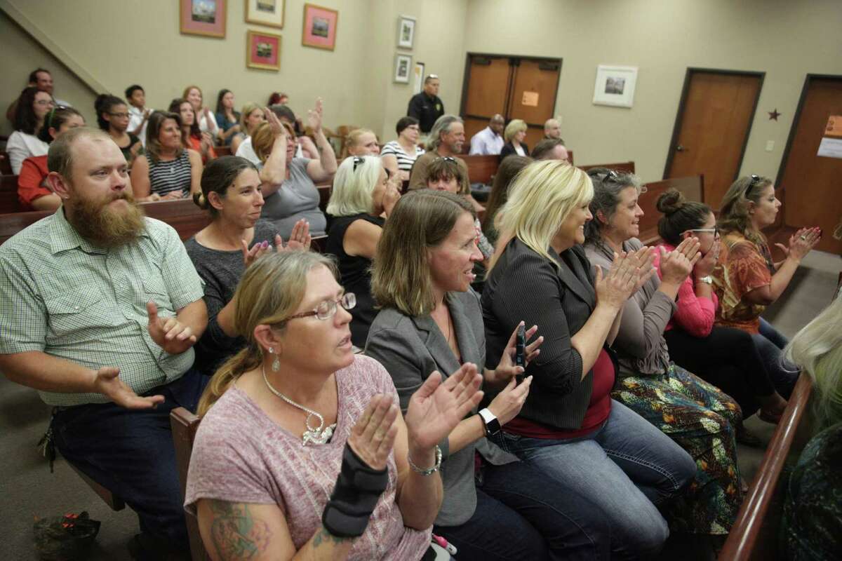 Supporters of Meadow Haven Horse Rescue react to Judge Rogelio Lopez's decision during a hearing at Bexar County Precinct 4 in San Antonio, Texas on July 25, 2017. The hearing was about whether the custody of 46 horses removed because of neglect would go back to the owner Andrew Schwartz or to Meadow Haven Horse Rescue, where the horses are currently being kept. The judge ruled to remove the horses from Schwartz's custody.