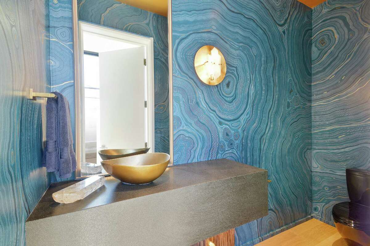 Concentric circles provide a nautical element to this powder room's design.