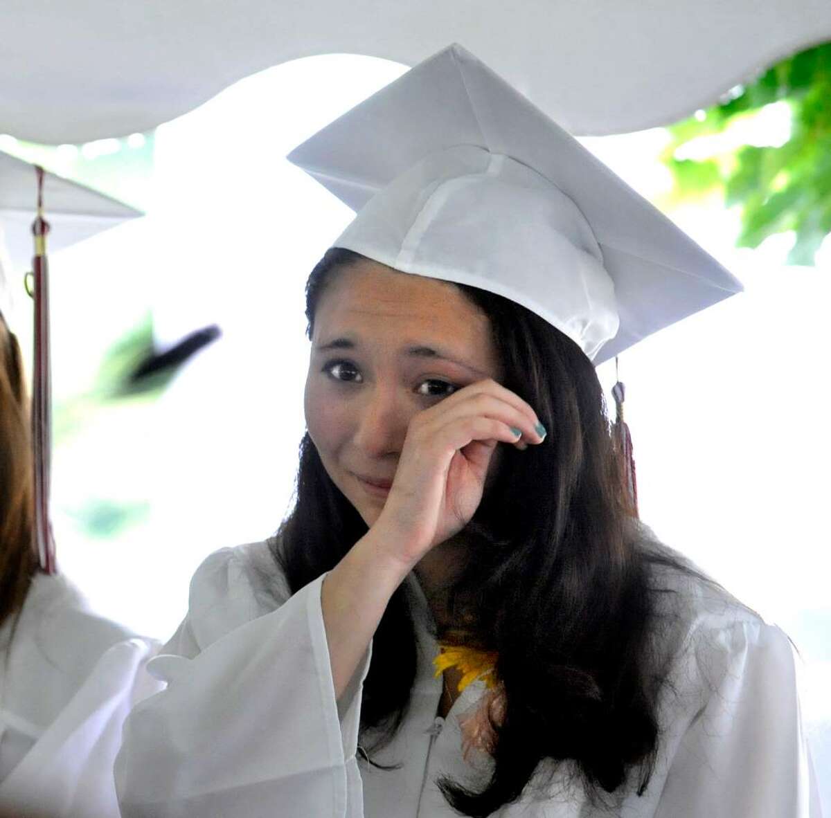 Laina Emily Piera wipes away a tear during Wooster School Commencement in Danbury, on Saturday, June 12, 2010.