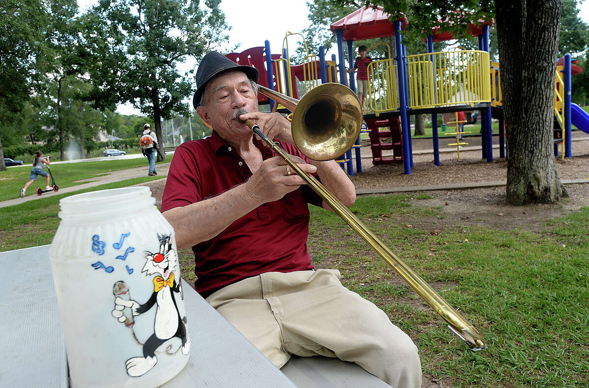 Henry Pressler, who performed with various bands and in duos under the stage name of Tony Alamo, continues to entertain with a variety of jazz and crooner classics. Pressler often spends afternoons in Rogers Park, his old fedora atop his head and trombone in hand. He still carries with him the tip jar his daughter decorated for him when she was a young child. Photo taken Wednesday, July, 26, 2017 Kim Brent/The Enterprise