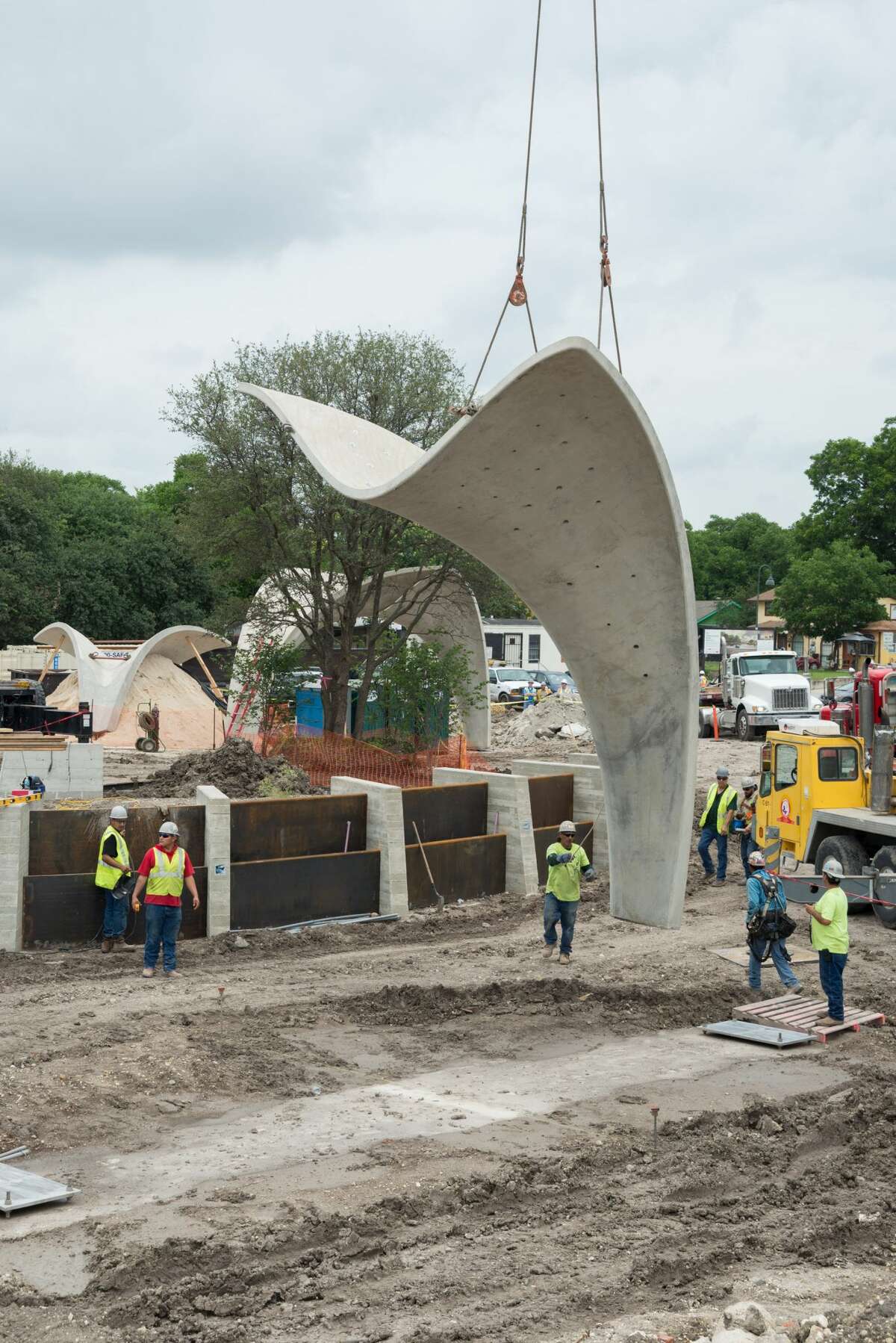Photos show a crane placing part of a pavilion in Confluence Park in July 2017.