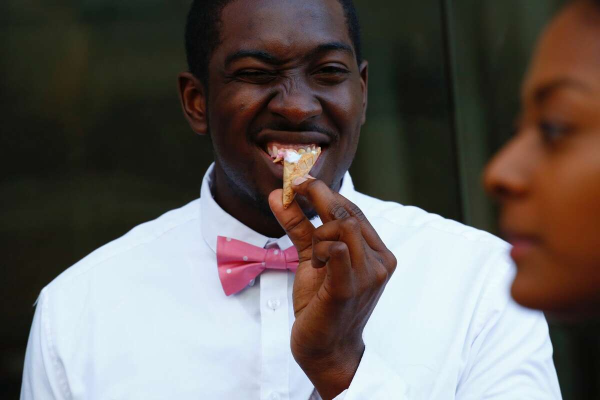 A doorman eats an Ice cream cone at the Museum of Ice Cream across from the Whitney Museum on July 29, 2016 in New York City.