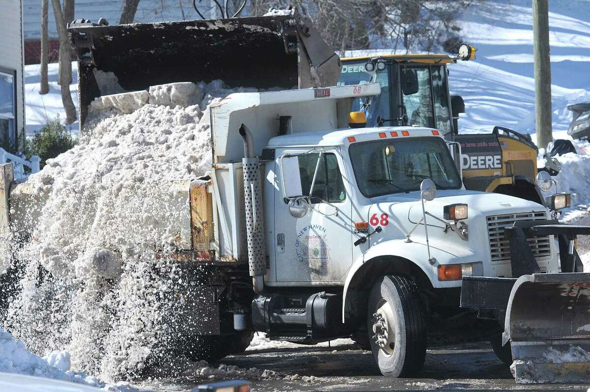 New Haven Public Works were busy removing snow along Fairfield Avenue early Monday afternoon.