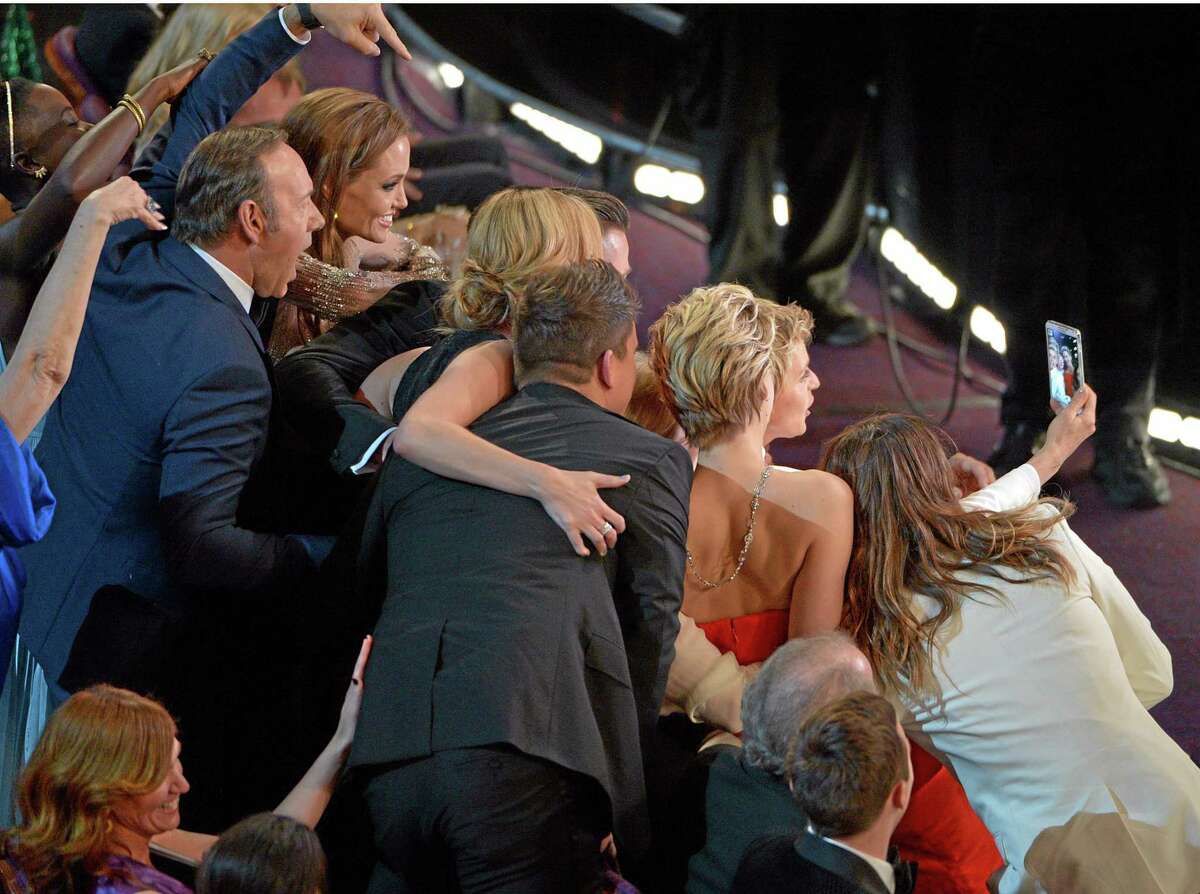 Kevin Spacey, from left, Angelina Jolie, Julia Roberts, Brad Pitt, Jennifer Lawrence, Ellen Degeneres and Jared Leto join other celebrities for a "selfie" during the Oscars at the Dolby Theatre on Sunday, March 2, 2014, in Los Angeles. (Photo by John Shearer/Invision/AP)