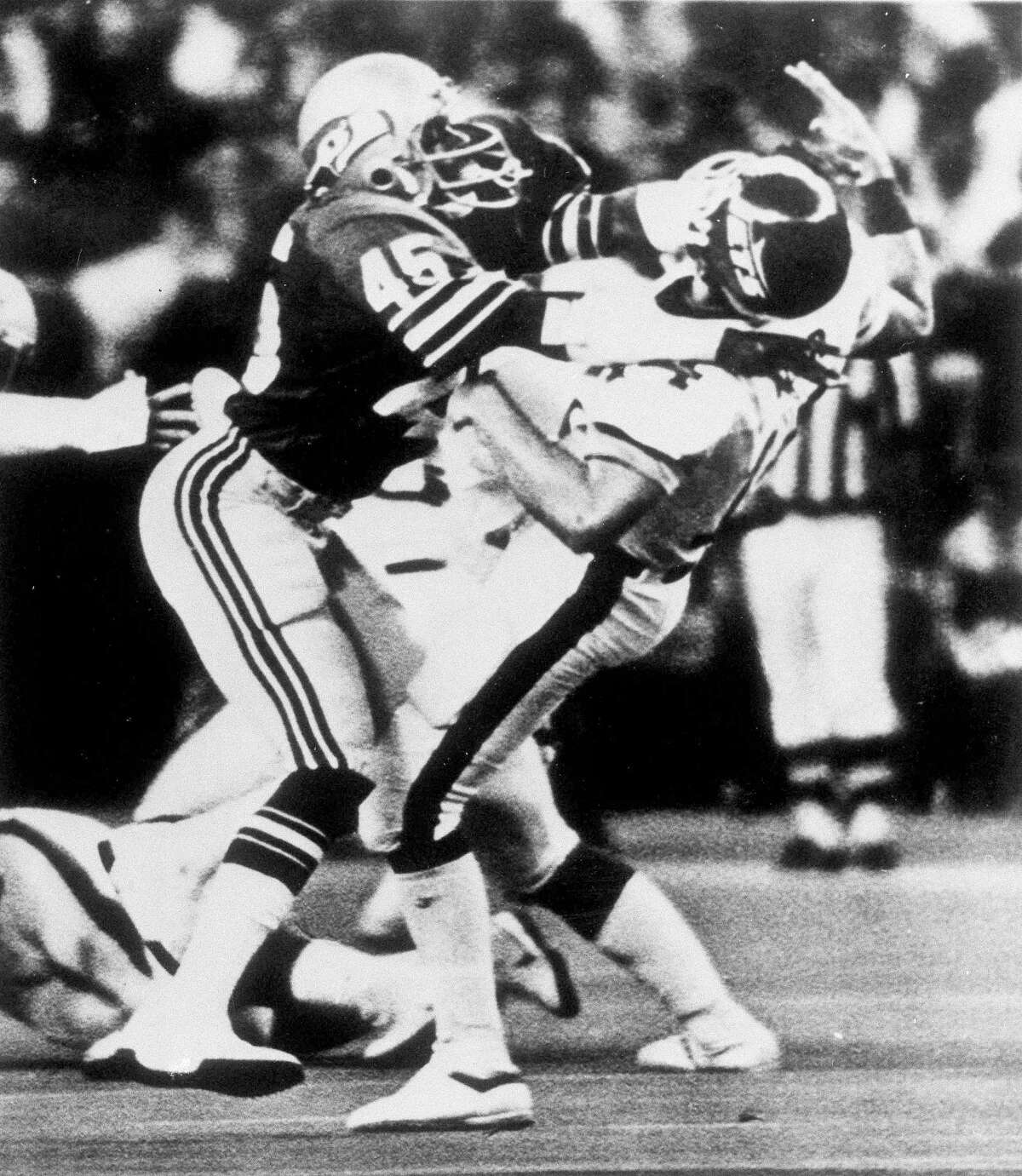 FILE - In this Dec. 6, 1981, file photo, Seattle Seahawks safety Kenny Easley (45) knocks New York Jets quarterback Richard Todd (14) to the ground during the first half of an NFL football game in Seattle. Easley is to to inducted Saturday at the Pro Football Hall of Fame. (AP Photo/File)