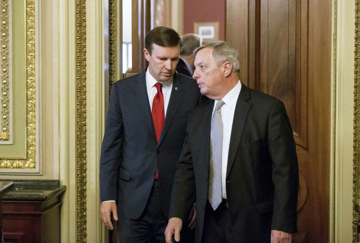 In this photo taken June 14, 2016, U.S. Sen. Chris Murphy, D-Conn., left, confers with Senate Minority Whip Richard Durbin, D-Ill., emerge from a closed-door party caucus on Capitol Hill in Washington. Murphy is launching a filibuster and demanding a vote on gun control measures. The move comes three days after people were killed in a mass shooting in Orlando.