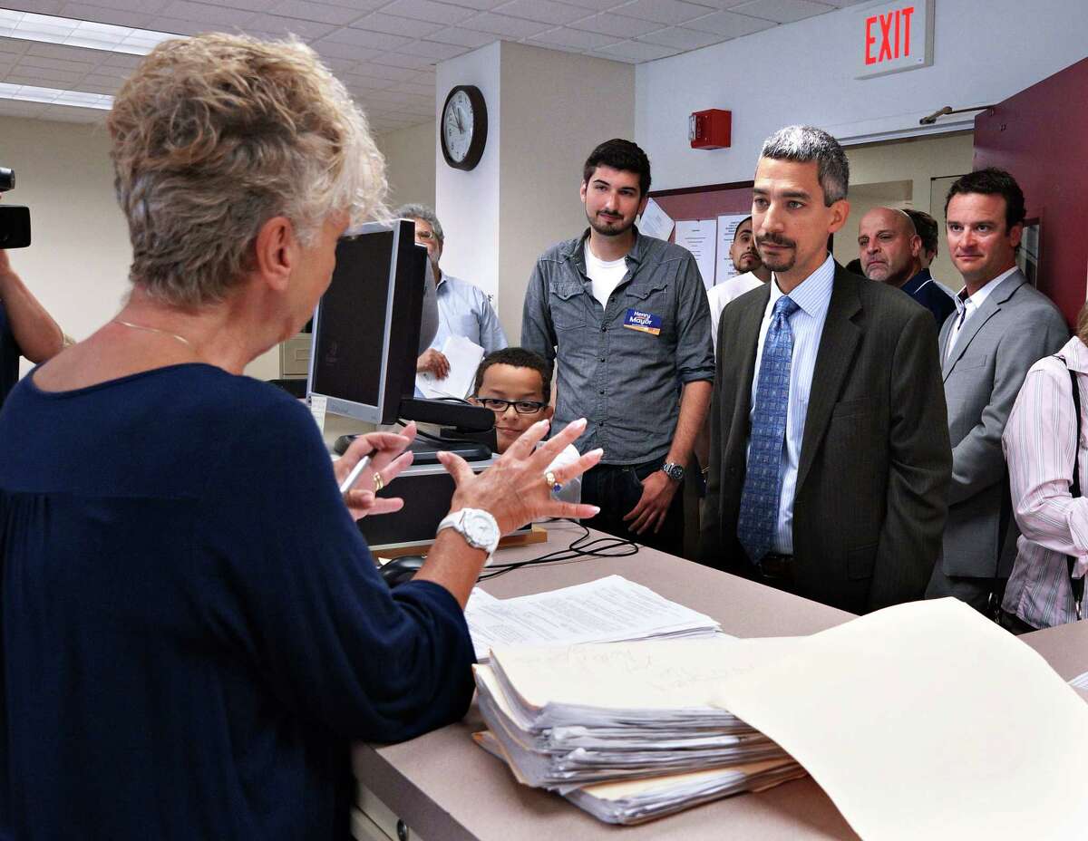 Peter Casolino ?‘ Register Mayoral candidate Henry Fernandez talks with Sharon Ferrucci, democratic registrar of voters for the city of New Haven as Fernandez dropped off over 6,000 signature petitions to be included on the primary ballot. pcasolino@newhavenregister.com