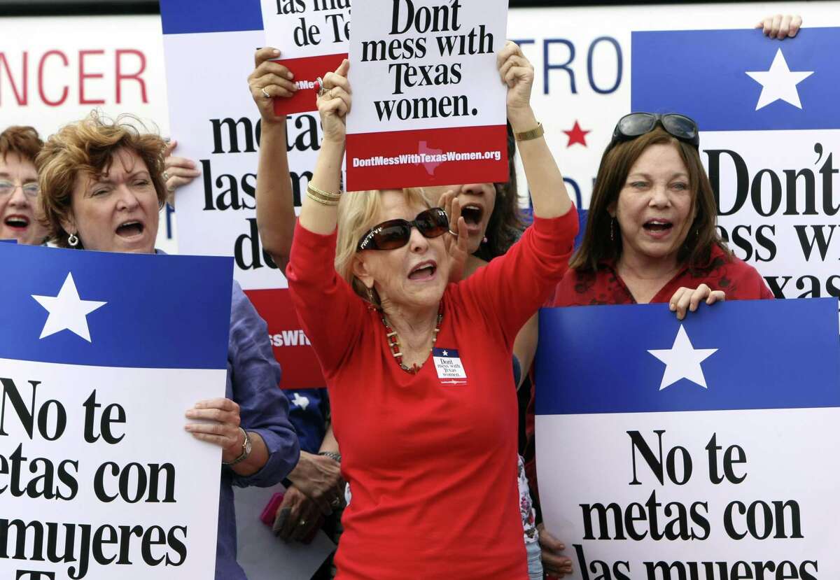 In 2012, women demonstrate at the Women’s Health Express, a bus event held in San Antonio to protest the attempt to cut Planned Parenthood from of state’s Women’s Health Plan. A reader says another defunding effort this year by the Trump administration is similarly wrong.