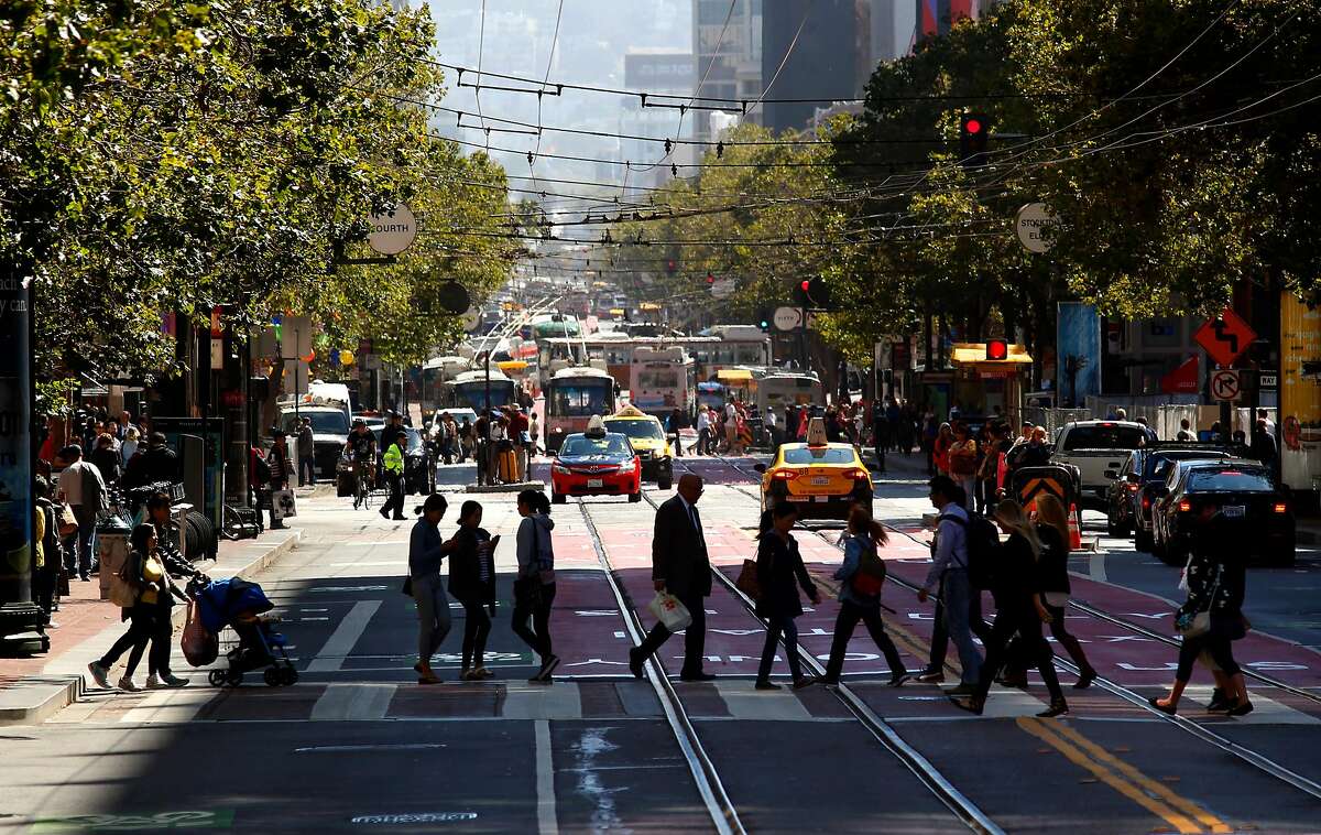 Pedestrians cross Market at Fourth St. in downtown San Francisco, California on Tues. June 28, 2016. Data from the safer Market Street project has shown fewer vehicles and safer behavior on the corridor since it took effect last August.