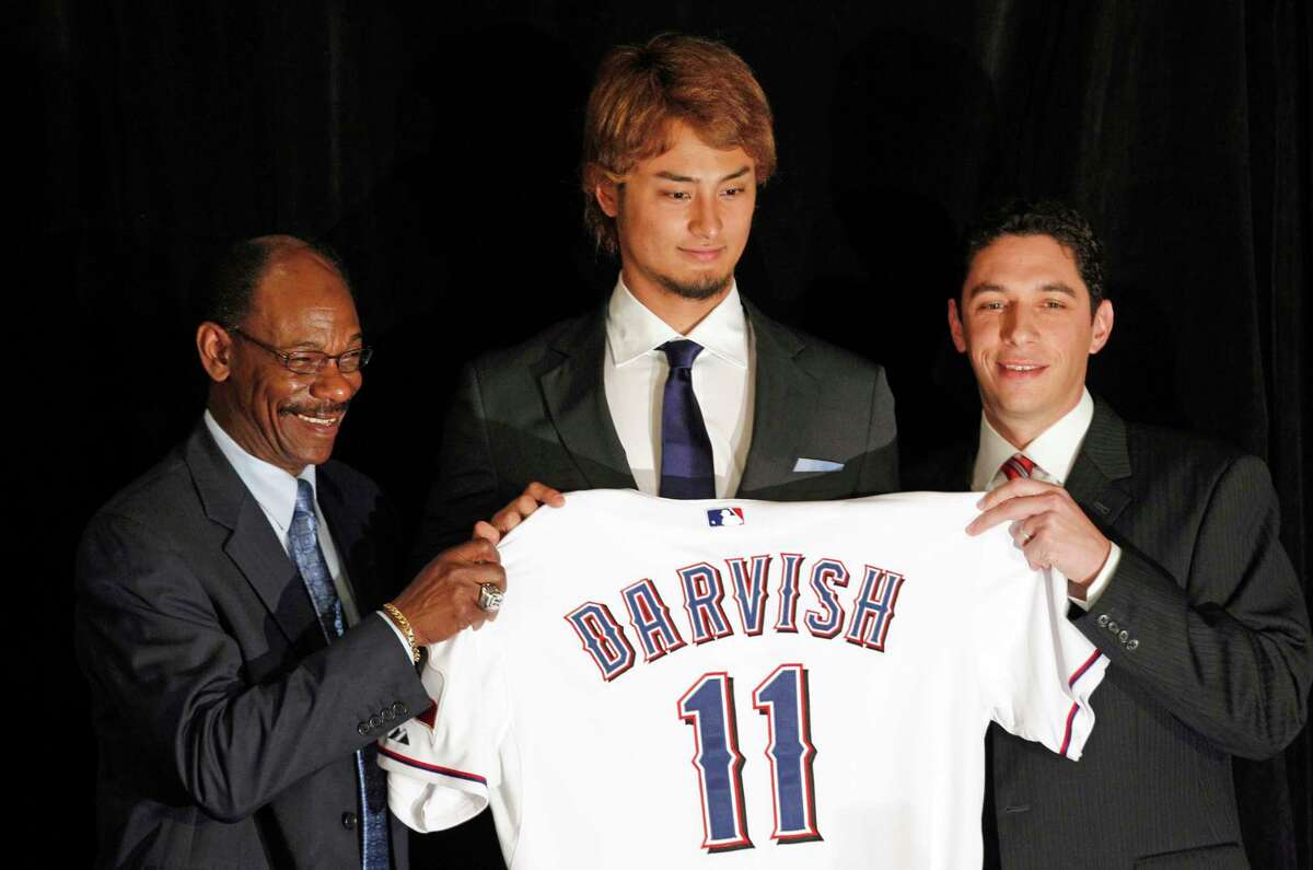 FILE - In this Jan. 20, 2012, file photo, new Texas Rangers pitcher Yu Darvish, center, poses with manager Ron Washington, left, and general manager Jon Daniel during a baseball news conference at Rangers Ballpark in Arlington, Texas. With a third straight AL West title long out of reach, and the push for a wild card becoming ever more difficult with each loss, the Rangers dealt the pitcher they spent more than two years scouting and more than $107 million to acquire for three minor league players. (AP Photo/LM Otero, File)