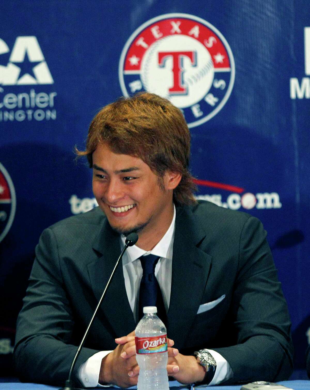 FILE - In this Jan. 20, 2012, file photo, new Texas Rangers baseball pitcher Yu Darvish smiles during a news conference at Rangers Ballpark in Arlington, Texas. When Yu Darvish arrived in Texas from Japan in 2012, the Rangers were coming off consecutive World Series appearances. With a third straight AL West title long out of reach, and the push for a wild card becoming ever more difficult with each loss, the Rangers dealt the pitcher they spent more than two years scouting and more than $107 million to acquire for three minor league players.(AP Photo/LM Otero, File)