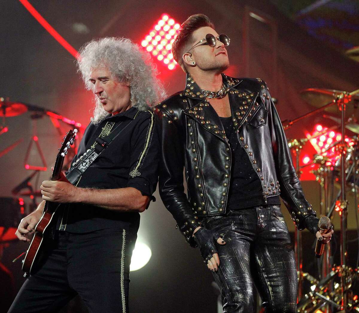 Guitarist Brian May stands next to Adam Lambert as Queen performs at the Toyota Center, Wednesday, July 9, 2014, in Houston. ( Karen Warren / Houston Chronicle )