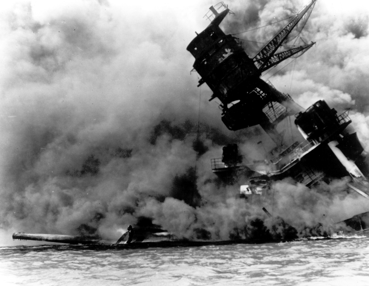 The sinking battleship USS Arizona begins to sink into the sea after being hit by a bomb during the Japanese surprise attack on Pearl Harbor, Hawaii, December 7, 1941. The majority of the crew members aboard, over 1100 men, lost their lives as the ship sank in less than ten minutes. (AP Photo)