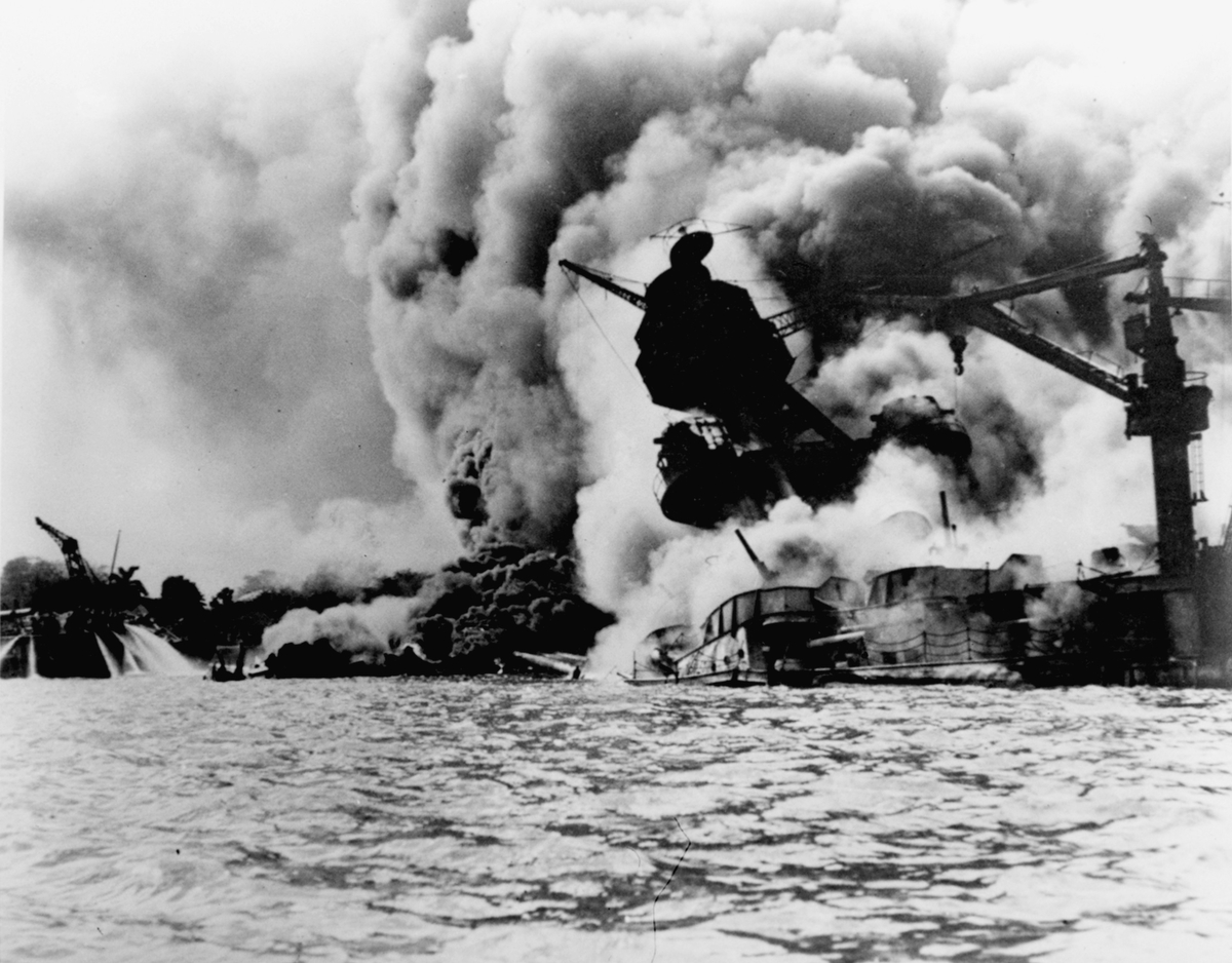 This photo shows the Japanese attack on Pearl Harbor on December 7, 1941. The USS Arizona is pictured in flames after the attack. (AP Photo/U.S. Navy)