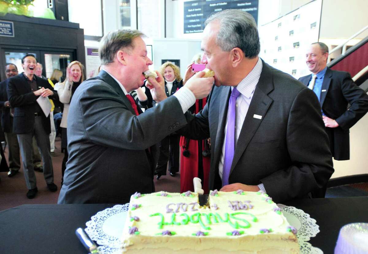 (Arnold Gold ?‘ New Haven Register) Shubert Theater Executive Director John Fisher (left) and New Haven Mayor John DeStefano, Jr., feed each other cake after a quit claim deed was signed transferring ownership of the Shubert Theater to the Connecticut Association for the Performing Arts in the lobby of the Shubert Theater in New Haven on 12/11/2013.