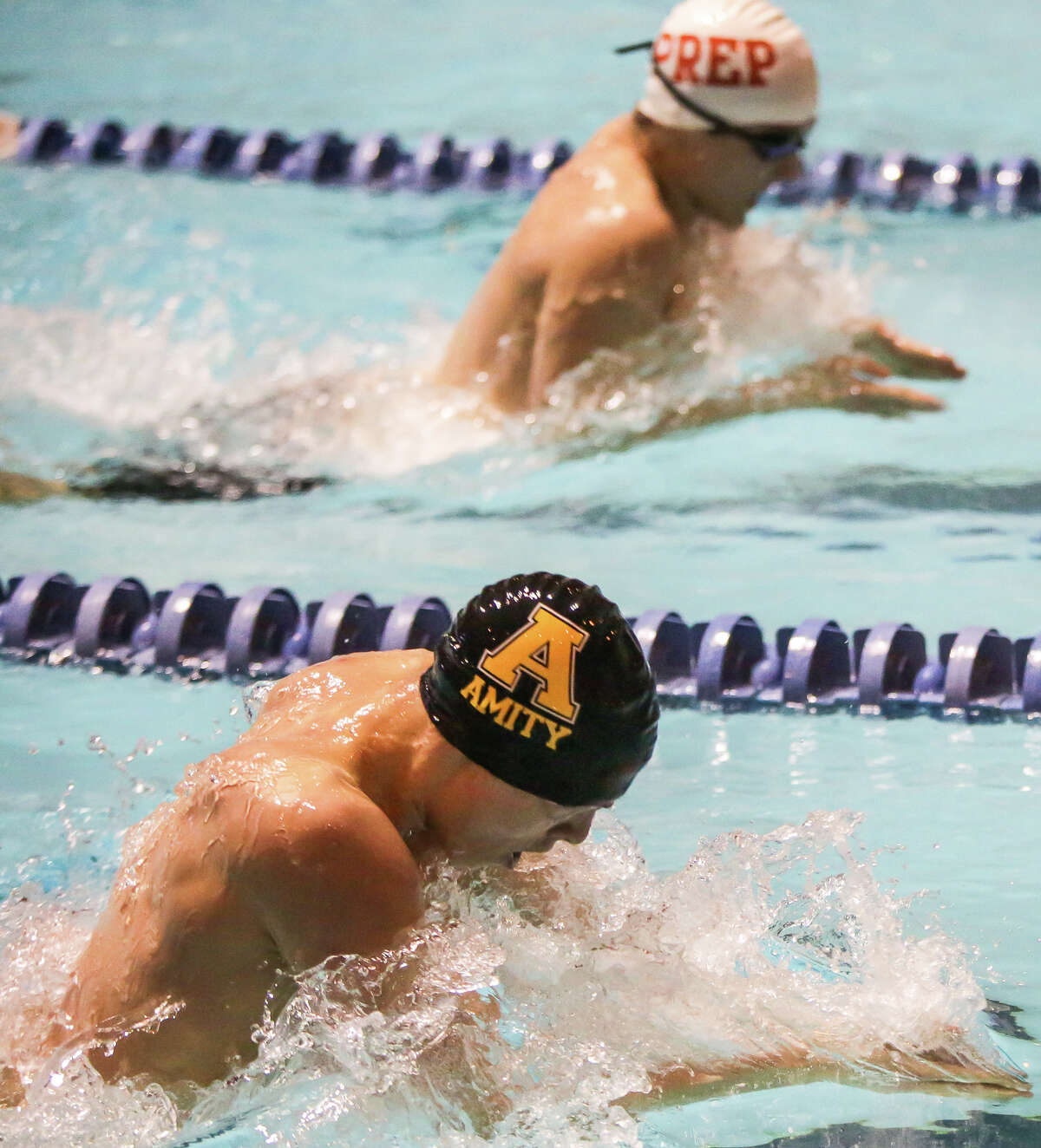 Amity Spartan swimmer AJ Pite is neck and neck with Fairfield Prep swimmer Brandon Cole in the 200 yard Individual Medley during the Boys Connecticut State open sweim meet at Yale.