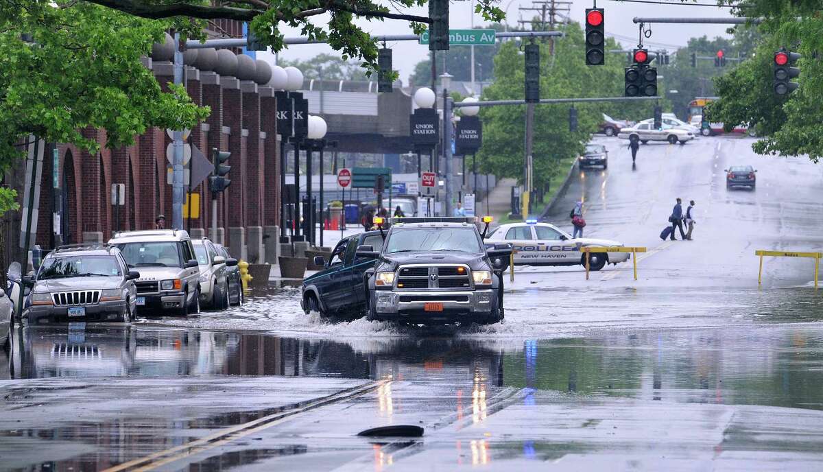 Flooding closes streets in New Haven area; creates manhole ‘geyser’