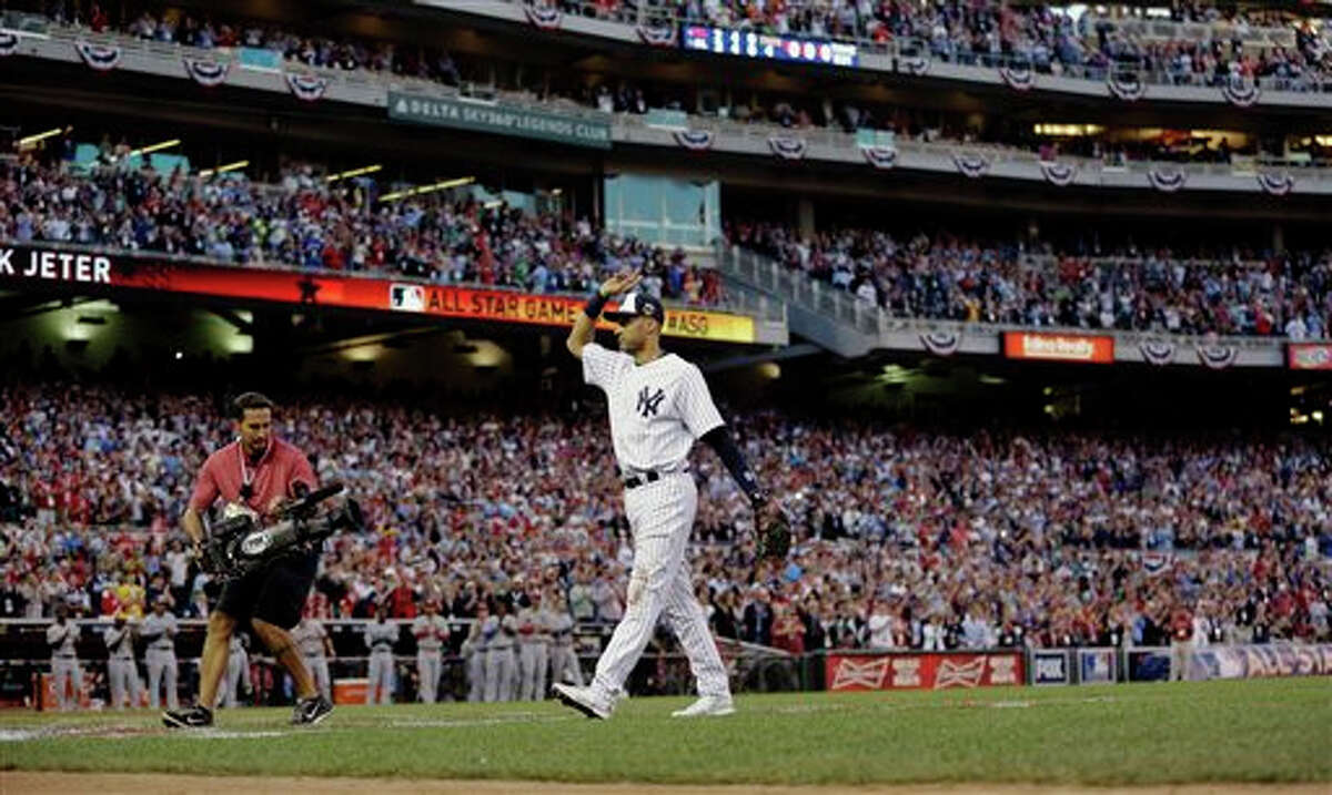 American League shortstop Derek Jeter, of the New York Yankees, waves as he is taken out of the game in the top of the fourth inning of the MLB All-Star baseball game, Tuesday, July 15, 2014, in Minneapolis.