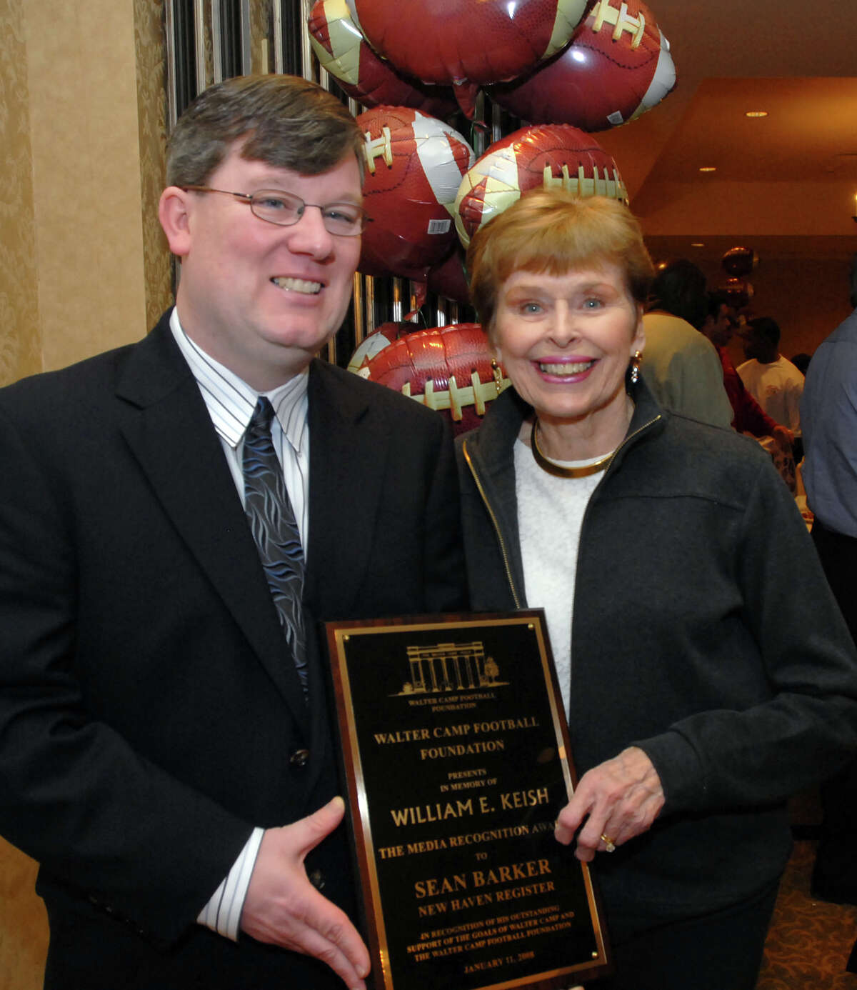 NE1//11/08 3Camp ML0423A Sean Barker of the New Haven Register left and Doris Keish with the William E. Keish Award given to Barker at one of the Walter Camp events at the Omni Hotel in New Haven. Photo by Mara Lavitt