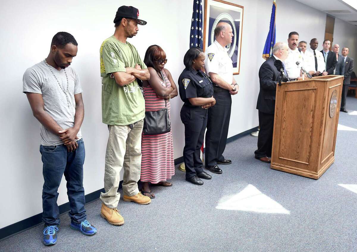 Left to right, Tyrese Jones' brother, William Jowers, and his parents, Jymeson and Felicia Jones, attend a press conference on 8/8/2014 at the New Haven Police Department announcing the arrest of Errol Godfrey-Hill in the shooting death of Tyrese Jones. Photo by Arnold Gold/New Haven Register agold@newhavenregister.com