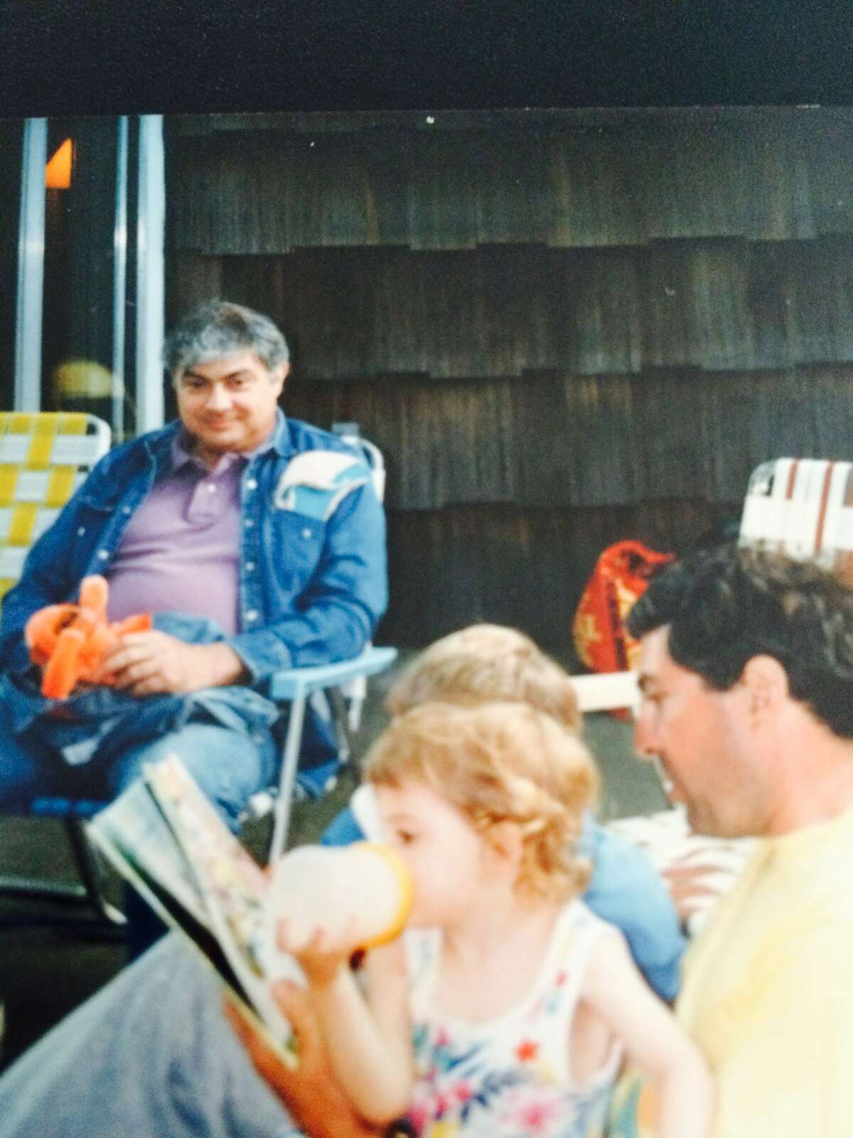 Michael Villano, seated in jean jacket, at an undated family gathering on Long Island with his brother, Steve Villano, in yellow shirt. (Photo courtesy of Steve Villano) ORG XMIT: 1rXBYcWNkzMLohkUe9G-