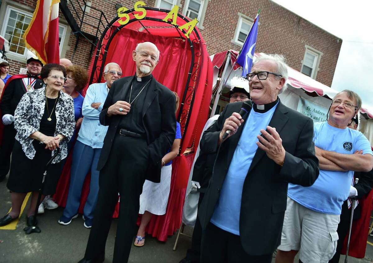 (Catherine Avalone - New Haven Register) Msgr. Gerard Schmitz, the new pastor of St. Michael's, is introduced to the Amalfitani-Italian community of New Haven following the opening parade, Thursday night, June 25, 2015 at the 115th Italian Festa celebration at St. Andrew The Apostle Society.
