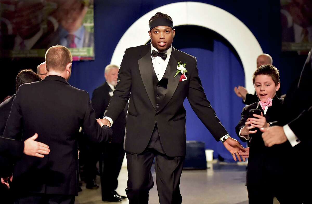 (Catherine Avalone - New Haven Register) Sam Anastasio, 11, 0f Woodbridge snaps a picture of the 2015 Walter Camp Football Foundation Player of the Year, Derrick Henry, as he is announced at the 49th annual awards dinner, Saturday, January 16, 2016, at Yale University Commons. Henry, a junior running back at University of Alabama leads the nation in rushing, 2,061 yards to set both school and SEC single-season records, was voted by the nation's 129 FBS head coaches and sports information directors.. Henry beat out finalists, Stanford's Christian McCaffrey, Oklahoma quarterback, Baker Mayfield, Clemson QB Deshaun Watson and Iowa defensive back Desmon King.