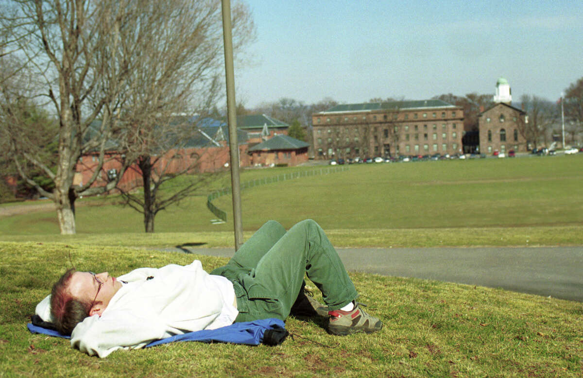 Jason Melbourne, a student at Wesleyan, enjoys the warm day by relaxing on campus.......photo by Irena pastorello