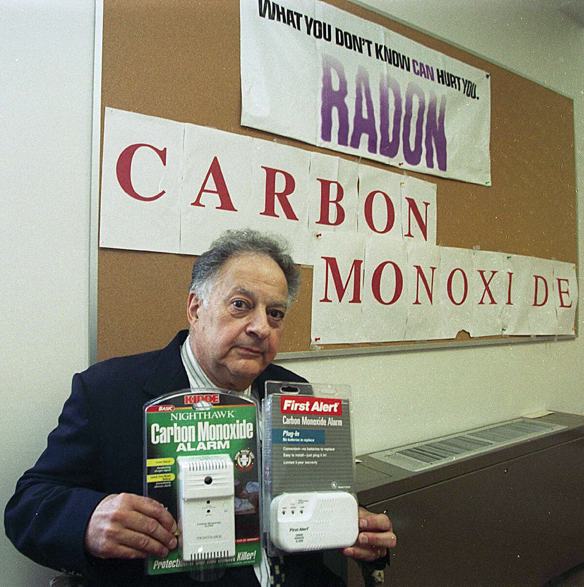 Thomas Armentano, Cromwell's Public Health Coordinator, holds two alarm-type CO2-detectors that can be purchased for the home........photo by Irena Pastorello......100100.irenaphoto