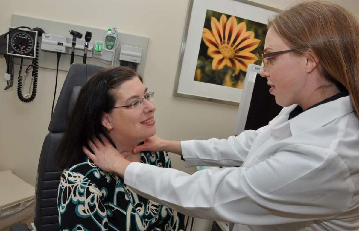 Dr. Sara Richer, endocrinologist, examines Laura Longueira's scar from thyroid surgery at St. Vincent's Hospital on Friday, June 4, 2010.