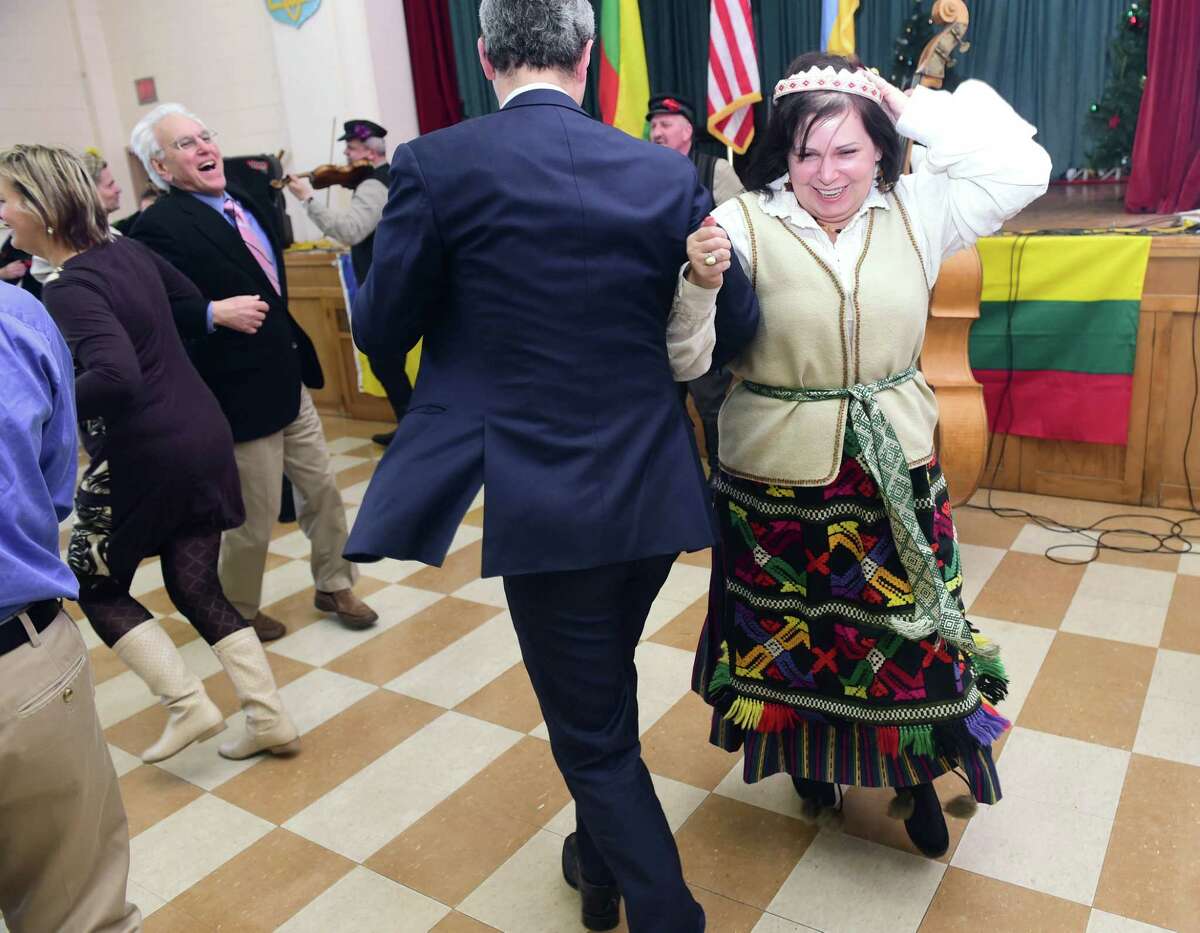 Members of the Lithuanian-American Community in traditional folk costumes dance to the music of the Seduva Guys of Lithuania with members of St. Michael's Ukrainian Catholic Church in New Haven on 2/15/2015. Photo by Arnold Gold/New Haven Register agold@newhavenregister.com