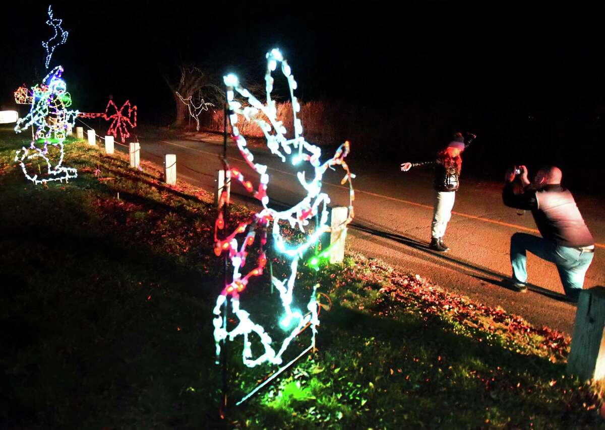 (Peter Hvizdak - New Haven Register) Bogi (CQ) Olah, 9, of Fairfield poses for a snapshot by her father, Roland Olah as they drive through the Fantasy of Lights displays at Lighthouse Point Park in New Haven Sunday, November 22, 2015. The L.E.D. light display attraction, a major fundraising event for the Easter Seals Goodwill Industriest can bring as many as 13,000 vehicles and raise approximately $125,000 which helps area residents with disabilities and other challenges. The attraction runs through January 6, 2016.