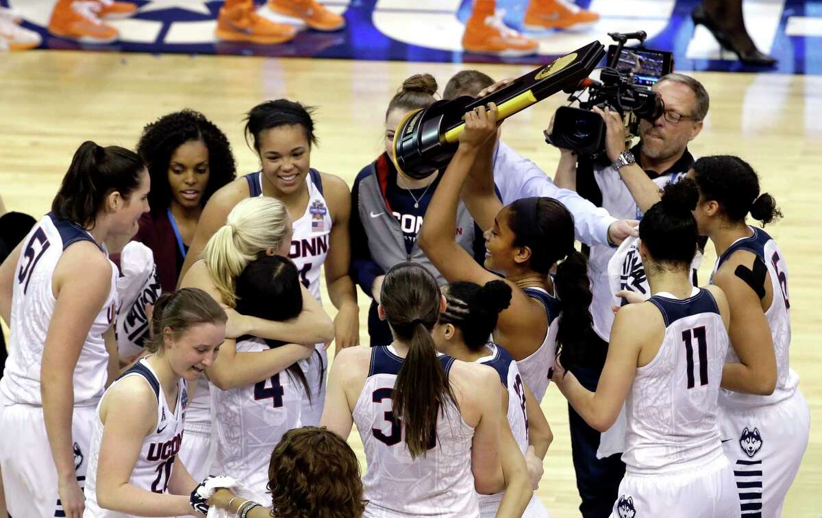 Members of Connecticut celebrate after defeating Syracuse in the championship game at the women's Final Four in the NCAA college basketball tournament Tuesday, April 5, 2016, in Indianapolis. Connecticut won 82-51.