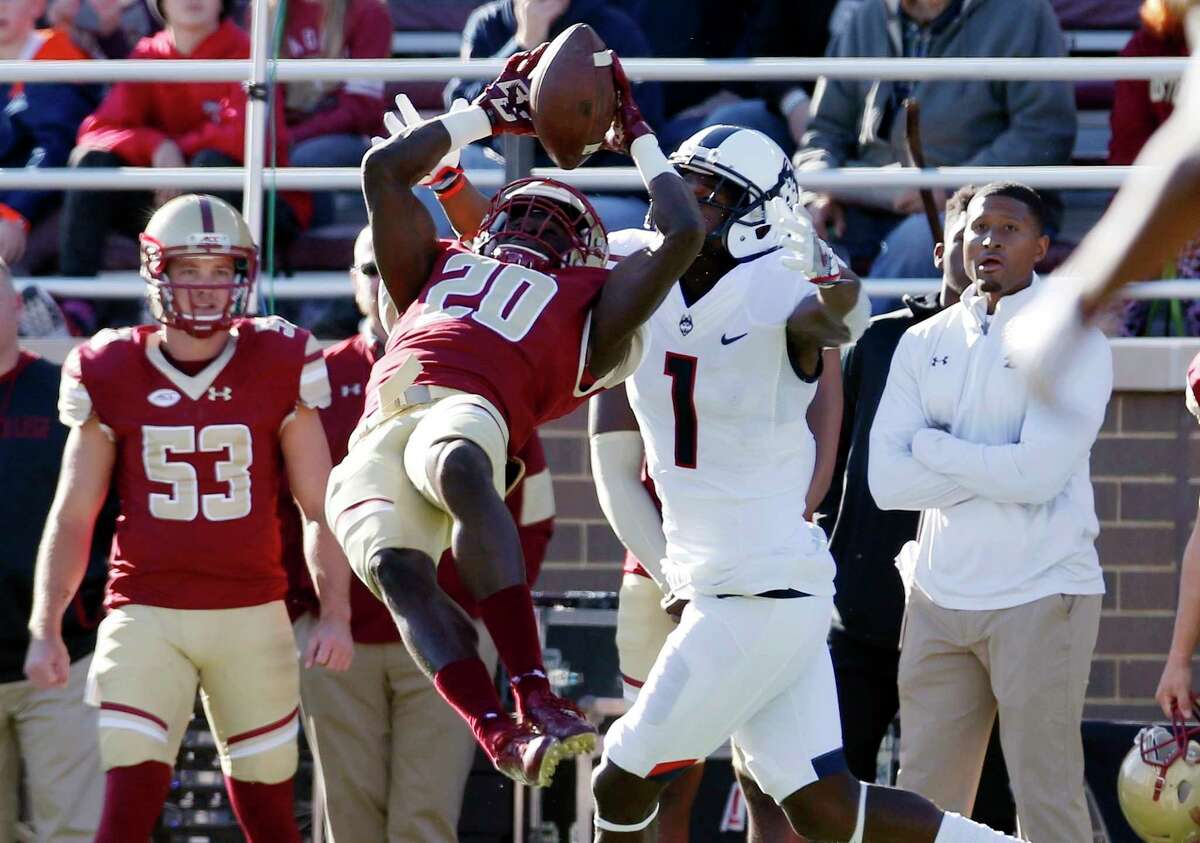 Boston College defensive back Isaac Yiadom (20) can not make the interception in front of Connecticut wide receiver Hergy Mayala (1) during the first half of an NCAA college football game in Boston, Saturday, Nov. 19, 2016.