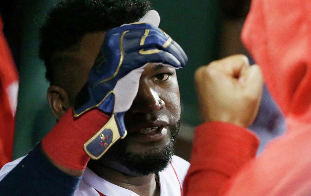 Boston Red Sox's David Ortiz interacts with teammates in the dug out after Travis Shaw was sent in to pinch run on Ortiz's single during the fifth inning of a baseball game against the Toronto Blue Jays in Boston, Saturday, Oct. 1, 2016.