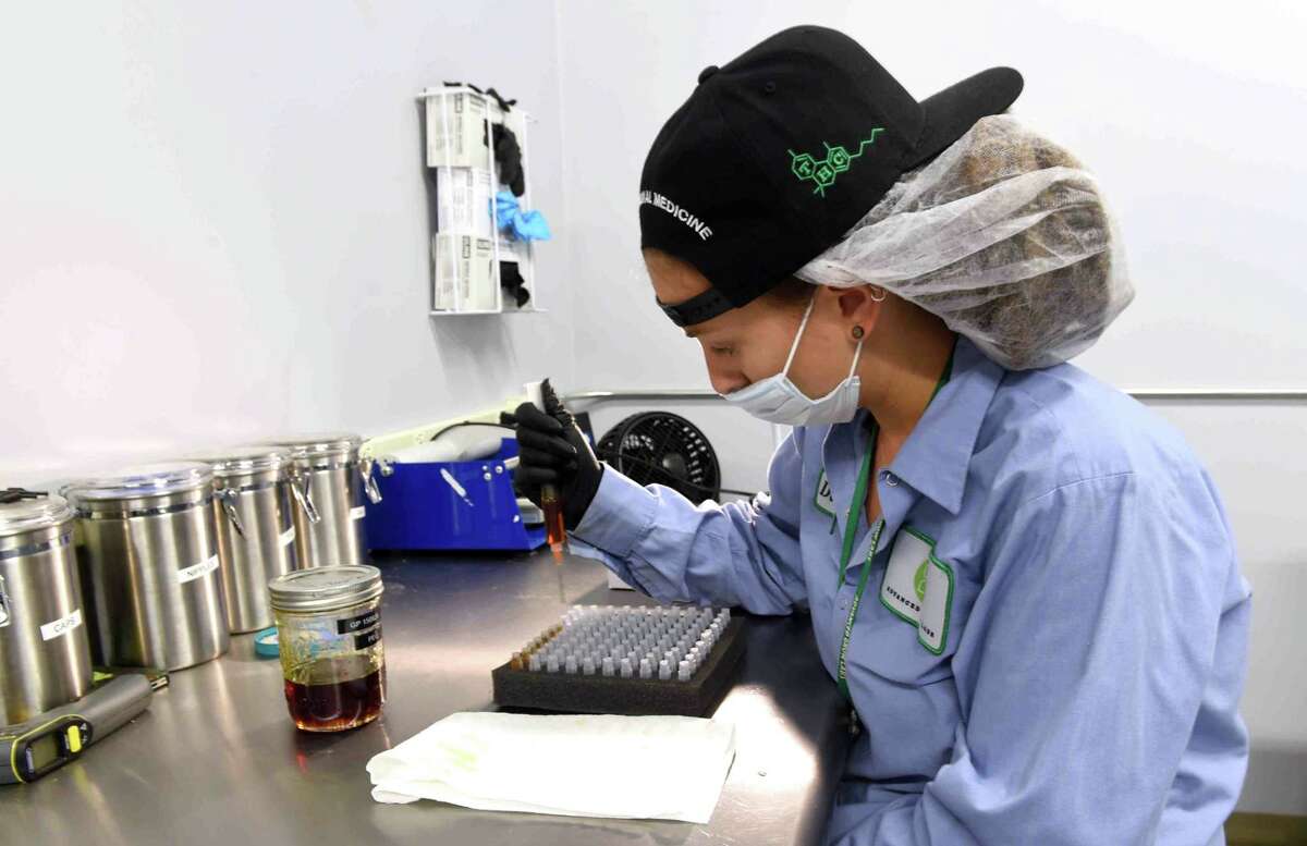 (Peter Hvizdak - New Haven Register) Production assistant Danielle Nachowitz injects a marijuana infused oil into vials at the medical marijuana production facility Advanced Grow Labs in West Haven, Connecticut, September 15, 2015. Advanced Grow Labs is one of four legalized growers of marijuana in Connecticut for the palliative use of pharmaceutical quality marijuana by Connecticut's healthcare system and its dispensaries for qualifying patients, according to the company's web site. The use of medical marijuana in Connecticut was legalized in 2012.