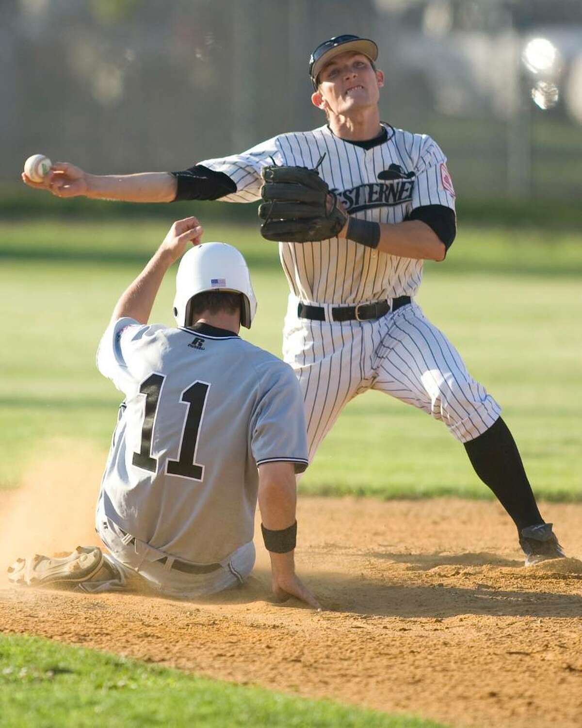 Westerners second baseman Tucker Nathans gets the force on a sliding Joseph Martin of the Bristol Collegiate, but fires to first too late to complete the double play Tuesday night at Rogers Park.