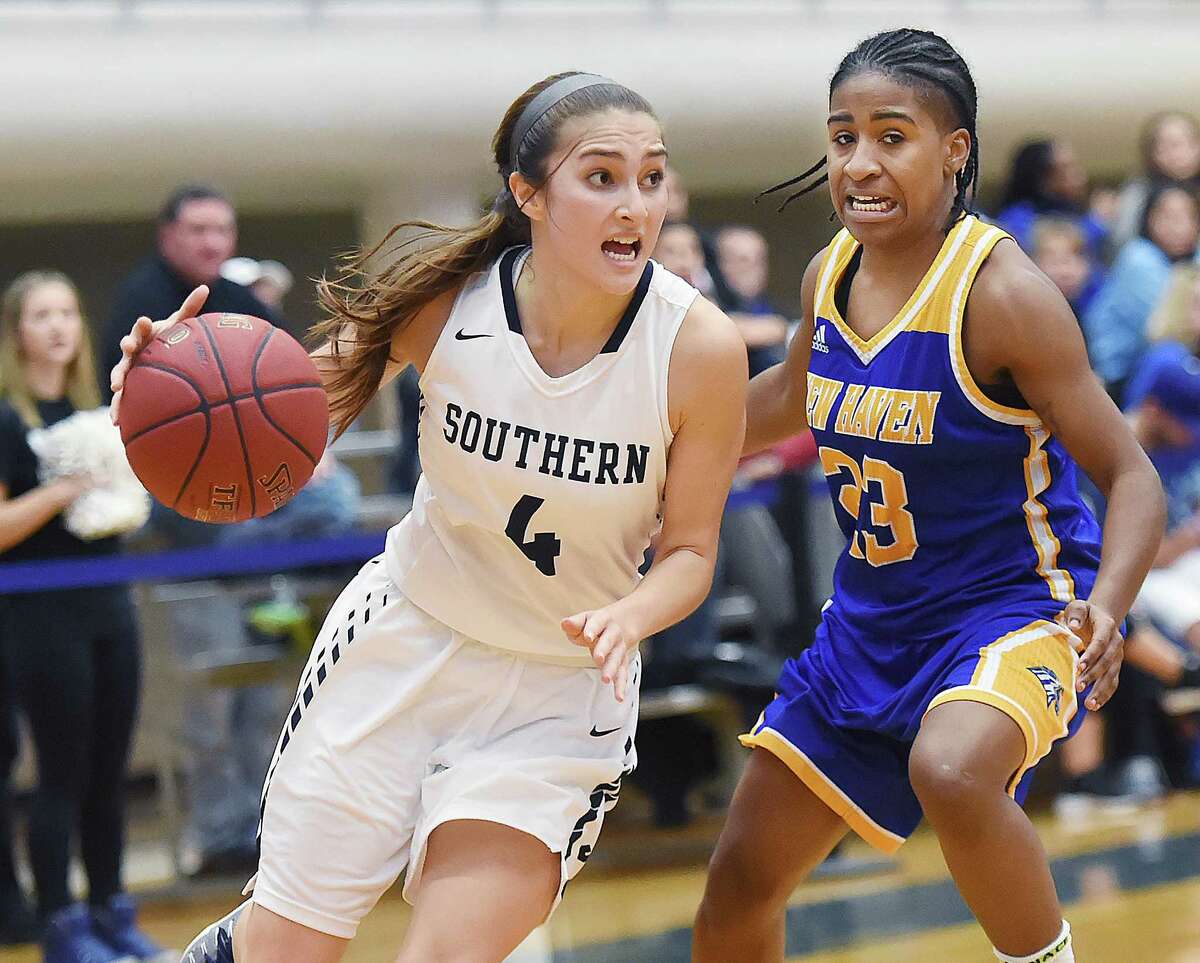 SCSU junior guard Murphy Murad drives past UNH senior guard Sadie King, Wednesday, November 30, 2016, at the Moore Field House at Southern Connecticut State University. The Owls won, 79-54. (Catherine Avalone/New Haven Register)