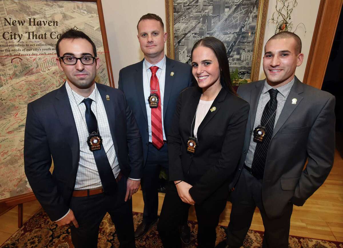 Officers Daniel Conklin, Ryan Macuizynski, Elizabeth White and Nicholas Katz of the New Haven Department of Police Services were promoted to detective, Friday, December 9, 2016, during a ceremony at the New Haven City Hall Atrium at 165 Church St. (Catherine Avalone/New Haven Register)