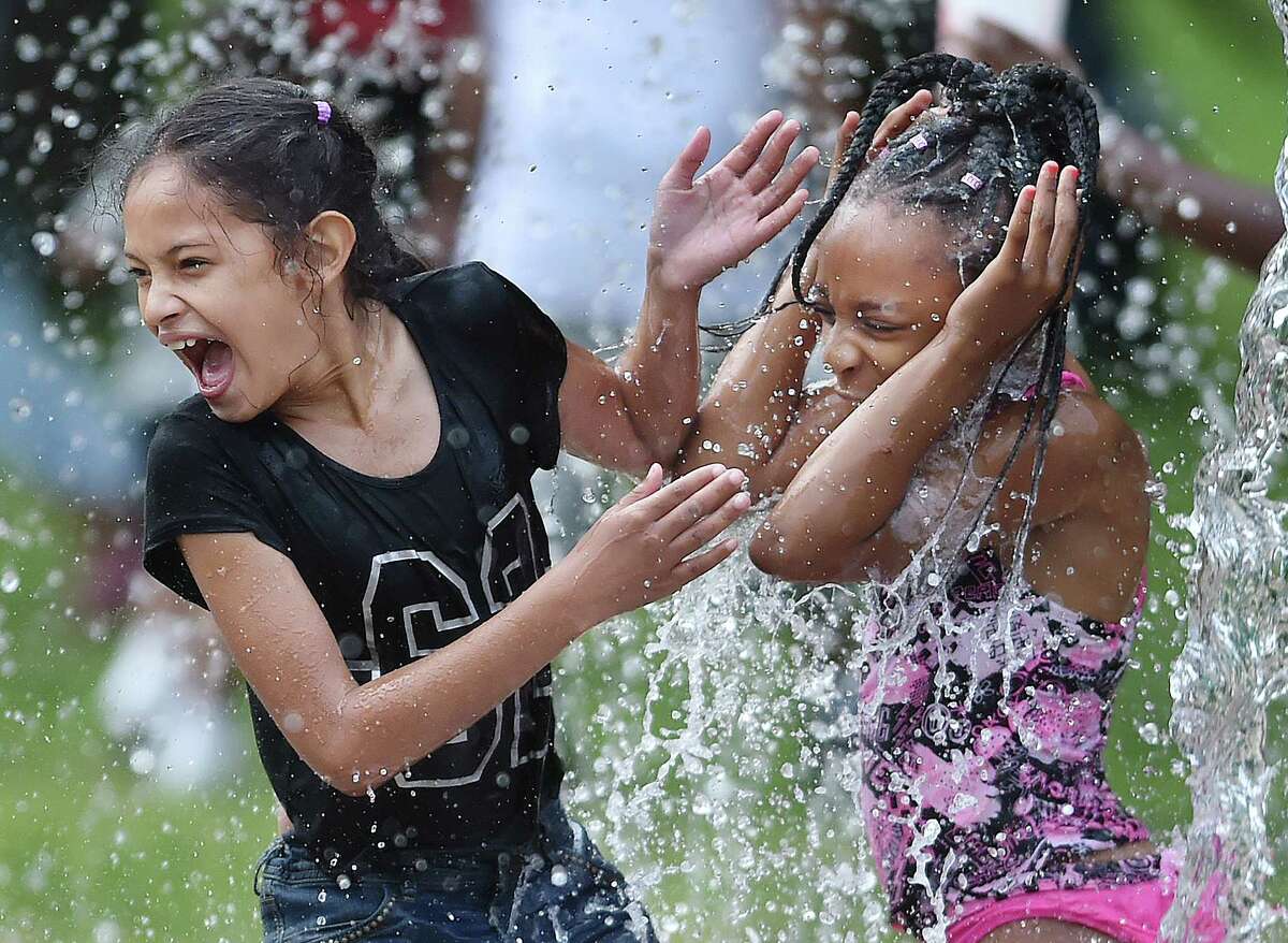 Girls play at the splash pad at Scantlebury Park on Ashmun Street in New Haven, Saturday, July 1, 2017. (Catherine Avalone / Hearst Connecticut Media)