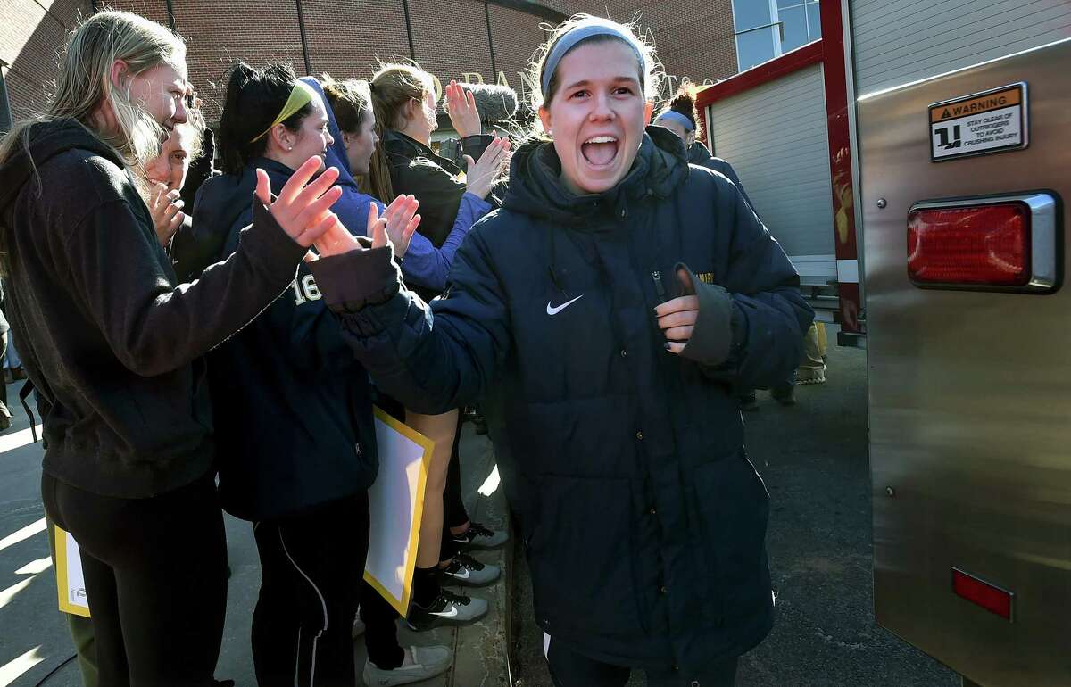 Quinnipiac guard Carly Fabbri walks through giving high fives to fans as the women's basketball team attends a Sweet 16 Send-Off Rally at the TD Bank Sports Center at the York Hill Campus in Hamden, Wednesday, March 22, 2017. The Bobcats will face #1 South Carolina, Saturday, March 25, 2017, in Stockton, California.