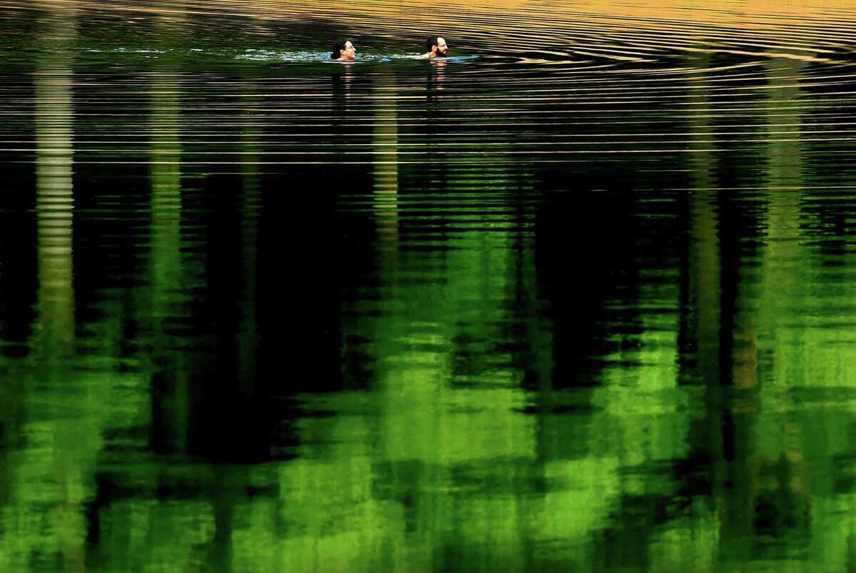 (Peter Hvizdak - New Haven Register) A couple take a cooling and reflective swim at the Wharton Brook State Park in Wallingford Tuesday afternoon, July 5, 2016.