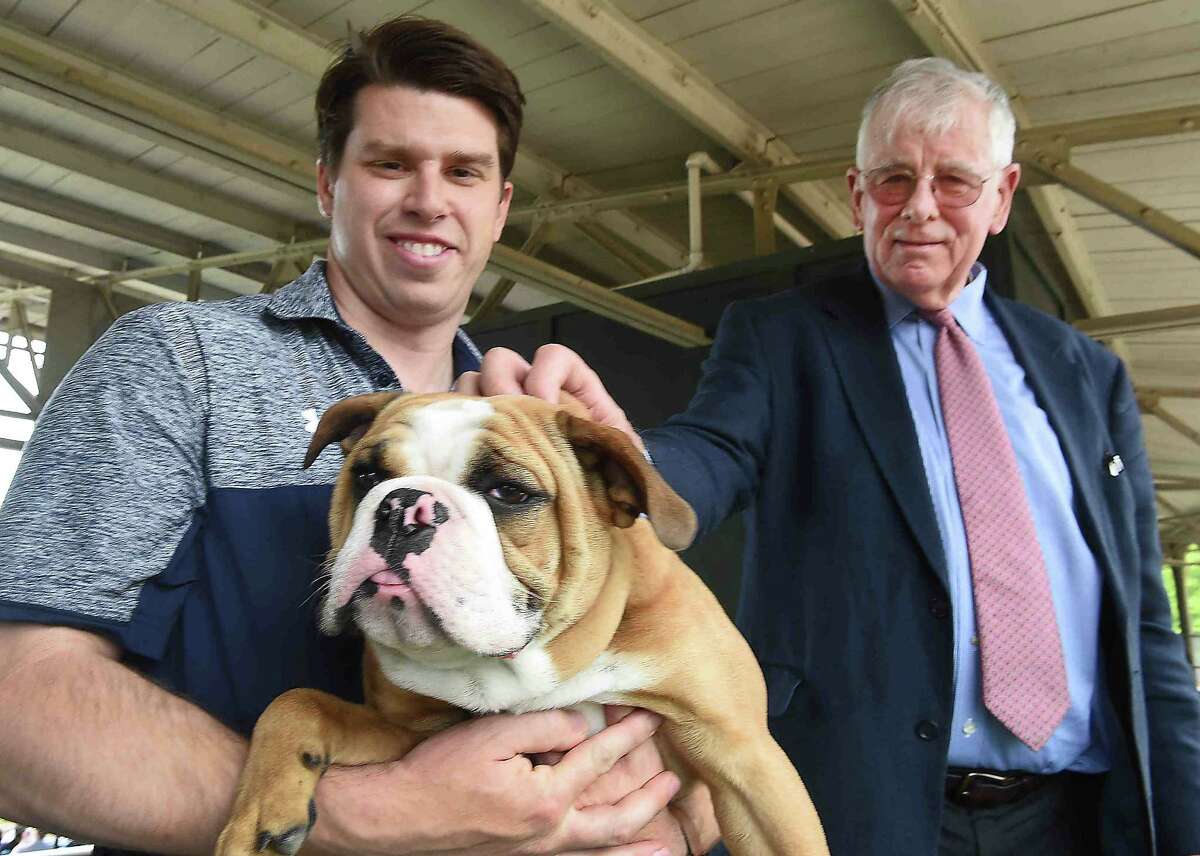 (Peter Hvizdak - New Haven Register) Kevin Discepolo, Assistant Athletic Director of Facilities, Operations, & Events, left, is the present caretaker of the Yale University mascot Walter, an English Bulldog, at Yale Field with Chris Getman of Hamden, 75, Yale Class of 1964, the former "keeper" of the Yale Bulldog Mascot Handsome Dan since 1983, during the Ivy League Baseball Championship at Yale Field in New Haven Tuesday, May 16, 2017