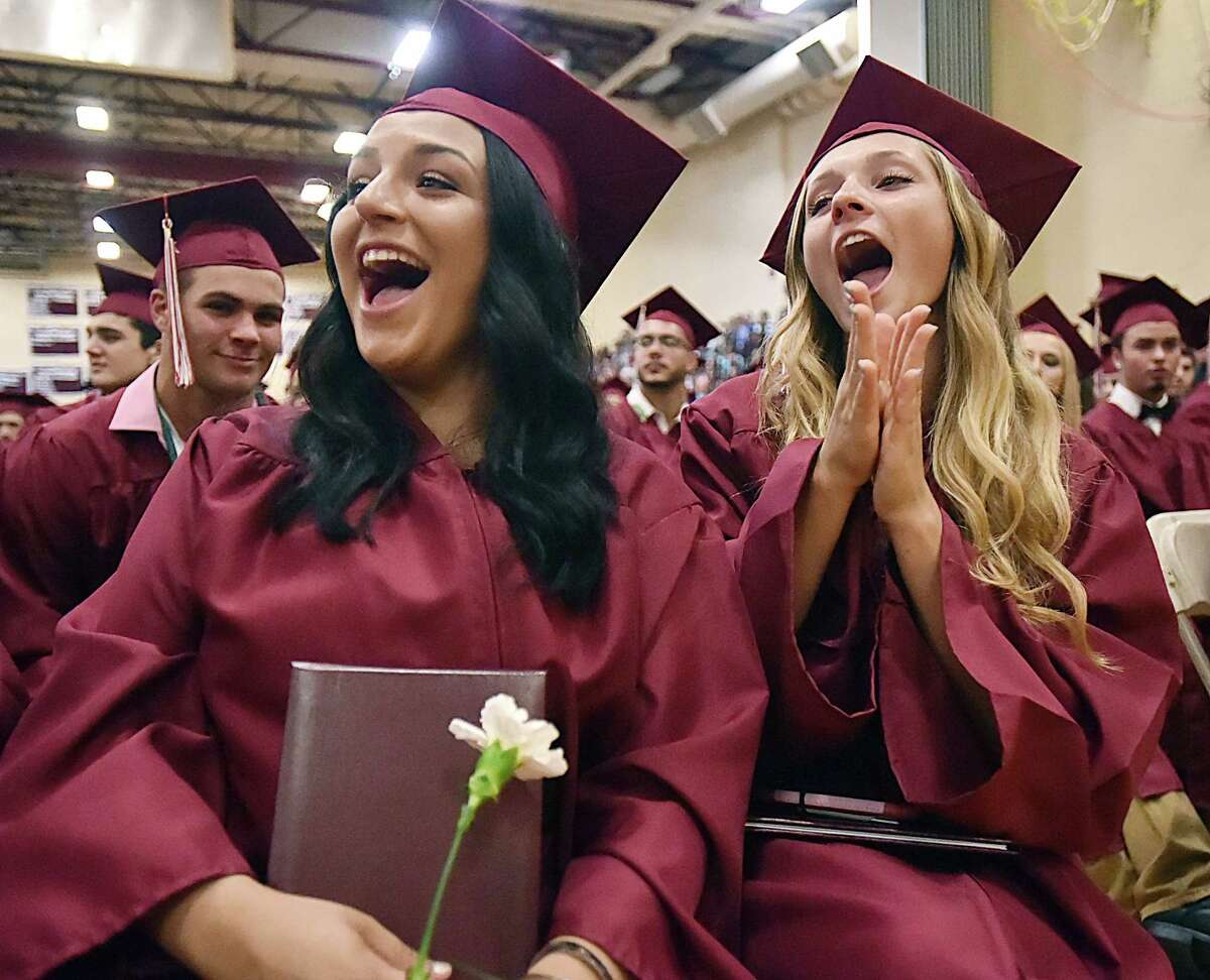Lucy Aquaro, at left and Jordyn Aurora cheer for a friend who is receiving their diploma at North Haven High School's class of 2017 graduation, Wednesday, June 21, 2017, at the Frederick J. Kelly Gymnasium at North Haven High School. (Catherine Avalone / Hearst Connecticut Media)