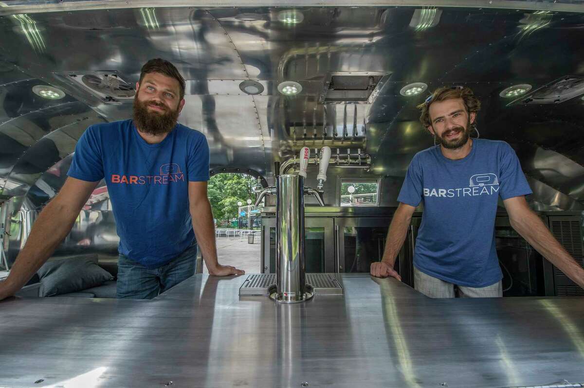 Ben Diedrich, left and Adam Lombard show off their BarStream rolling bar outside the Saratoga Performing Arts Center Thursday July 27, 2017 in Saratoga Springs, N.Y. (Skip Dickstein/Times Union)