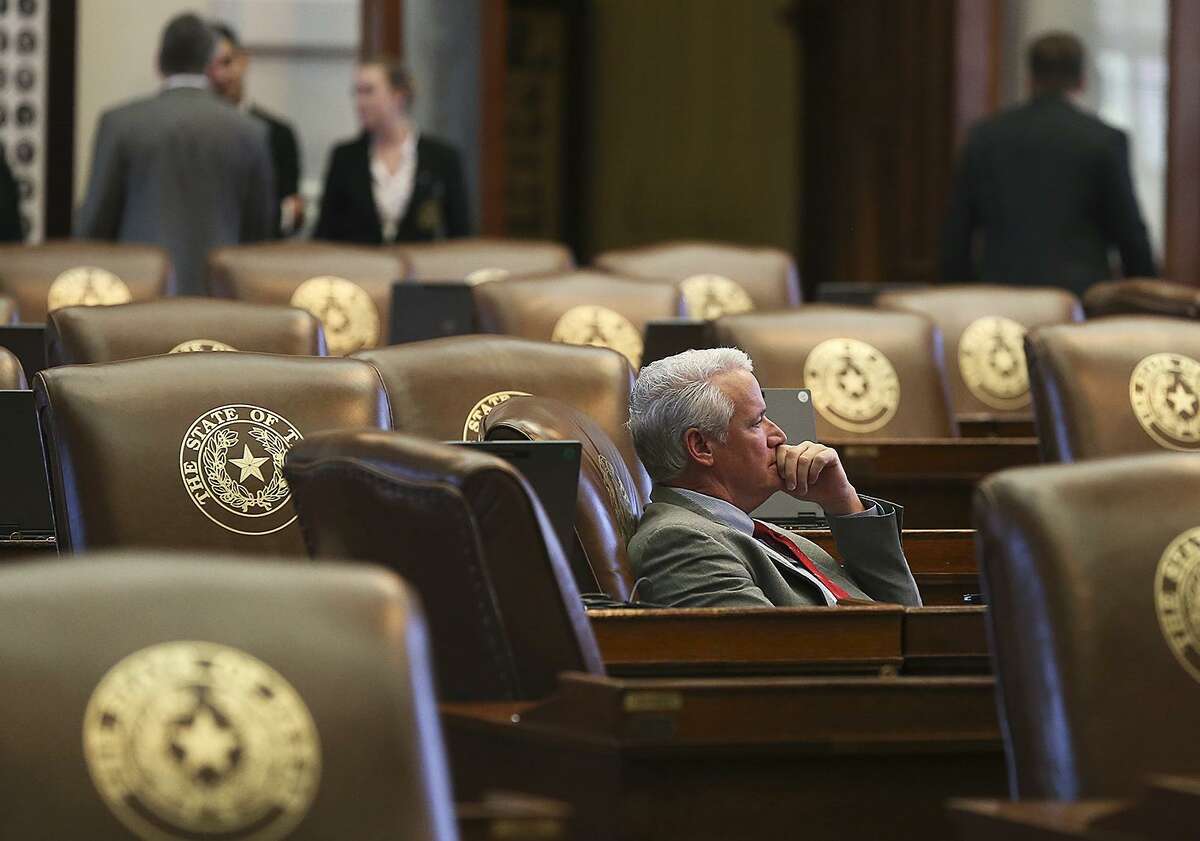 Representative Lyle Larson, R-San Antonio, contemplates as he looks toward the south windows as legislators meet in the House of Representatives on the last day of the second special session on July 30, 2013.