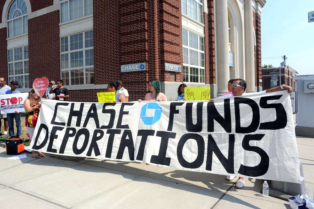 Protesters say Chase profits from suffering of migrants