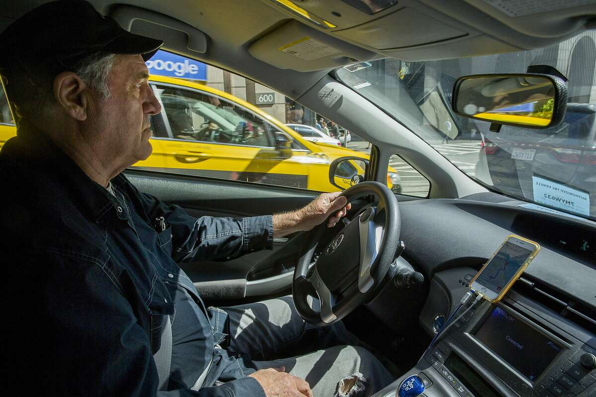 Uber driver John Leibbrand drives away from Market Street in downtown San Francisco on Wednesday, Aug. 2, 2017, in San Francisco, Calif. A plan calls to ban cars, including Uber and Lyft, from Market Street�s eastern reaches while delivering continuous protected bike lanes and Muni-only lanes. It would make room for taxis and other commercial vehicles such as delivery trucks. But it would get rid of Market Street�s signature brick sidewalks.