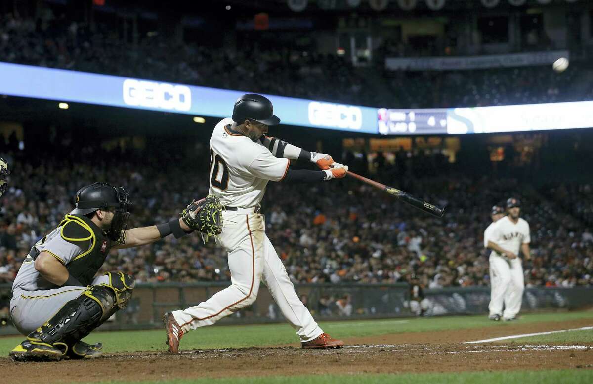 San Francisco Giants’ Eduardo Nunez hits a two-run double in front of Pittsburgh Pirates catcher Francisco Cervelli during the fourth inning of a baseball game in San Francisco on July 25, 2017.
